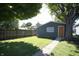 Green backyard featuring a quaint outbuilding and mature tree at 234 S State Ave, Indianapolis, IN 46201