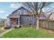 Charming home backyard featuring a fire pit, lawn, and gray wood-sided house at 234 S State Ave, Indianapolis, IN 46201