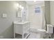 Bright bathroom with a white vanity, subway tile shower, and modern fixtures at 234 S State Ave, Indianapolis, IN 46201