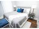 Bedroom showcases a plush queen bed with decorative pillows and coordinating side tables with lamps at 234 S State Ave, Indianapolis, IN 46201