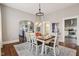 Bright dining room features a dining table set for six, chandelier, and views into living room and kitchen at 234 S State Ave, Indianapolis, IN 46201