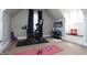 Bright exercise room featuring a Peloton bike, shelving, yoga mats, and charming built-in bench seat at 234 S State Ave, Indianapolis, IN 46201