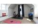 Bright, carpeted exercise room with a Peloton bike, workout equipment, and a cozy built-in bench at 234 S State Ave, Indianapolis, IN 46201