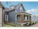 Charming home exterior with brick front porch, gray wood siding, and white trim at 234 S State Ave, Indianapolis, IN 46201
