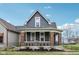 Charming two-story home with gray siding, brick foundation and inviting front porch at 234 S State Ave, Indianapolis, IN 46201