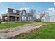 Property with a spacious gravel driveway, shed, and a charming two-story home with mixed siding at 234 S State Ave, Indianapolis, IN 46201