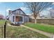 Charming two-story home with freshly manicured lawn and walkway at 234 S State Ave, Indianapolis, IN 46201