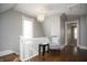 Hallway features wood floors, a white railing, and a comfortable chair with pillow at 234 S State Ave, Indianapolis, IN 46201