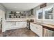 Well-lit kitchen boasts modern appliances, open shelving, and ample counter space for cooking and entertaining at 234 S State Ave, Indianapolis, IN 46201