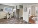 Kitchen area with stainless steel refrigerator, dining table, and view into the hallway at 234 S State Ave, Indianapolis, IN 46201