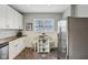 Charming kitchen nook featuring a small dining table, chairs, and stainless steel refrigerator at 234 S State Ave, Indianapolis, IN 46201