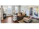Bright living room with hardwood floors, neutral sofa, and stylish ottoman at 234 S State Ave, Indianapolis, IN 46201