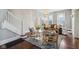 Elegant living room showcasing hardwood floors, a decorative rug, and staircase at 234 S State Ave, Indianapolis, IN 46201