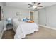 Cozy bedroom offers soft carpet, a ceiling fan, and a tray with a floral arrangement at 234 S State Ave, Indianapolis, IN 46201