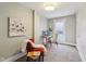 Bright, carpeted room with a desk, chair, window, and an open door at 234 S State Ave, Indianapolis, IN 46201