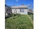 Grassy backyard features a swing set and playset for to enjoy in a fenced in yard at 2509 Bristlecone Dr, Indianapolis, IN 46217