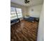 Cozy bedroom features hardwood floors, a ceiling fan, and a large window at 2509 Bristlecone Dr, Indianapolis, IN 46217