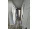 Bright hallway features wood-look tile flooring, utility closet and leads to other rooms at 2509 Bristlecone Dr, Indianapolis, IN 46217