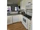 Cozy kitchen featuring granite countertops, open layout to the entry, and modern white appliances, perfect for cooking at 2509 Bristlecone Dr, Indianapolis, IN 46217