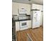 The kitchen showcases white cabinetry and appliances, complementing the hardwood floors at 2509 Bristlecone Dr, Indianapolis, IN 46217