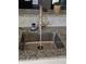 Close up of a stainless kitchen sink with a modern faucet and patterned backsplash at 2509 Bristlecone Dr, Indianapolis, IN 46217