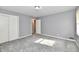 Neutral bedroom featuring gray walls, gray carpet, and a closet with sliding doors at 2543 Thayer Ct, Anderson, IN 46011