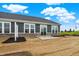 Home backyard with gray siding, brick foundation, and sliding glass doors to patio at 260 Onset Way, Westfield, IN 46074