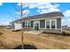 View of the backyard featuring a modern home exterior with large windows and a small patio at 260 Onset Way, Westfield, IN 46074