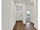 Bright entryway featuring hardwood floors, a white front door, and an open view to the living area at 260 Onset Way, Westfield, IN 46074
