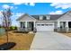 Charming home showcasing a two-car garage, grey shingle siding, stone accents, and professional landscaping at 260 Onset Way, Westfield, IN 46074