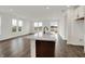 Open kitchen featuring an eat-in island, large windows, and wood floors at 260 Onset Way, Westfield, IN 46074
