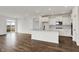Modern kitchen with white cabinets, stainless steel appliances, and a center island with quartz countertops at 260 Onset Way, Westfield, IN 46074