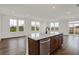 Bright eat-in kitchen featuring dark-stained island with stainless dishwasher, and large windows overlooking the yard at 260 Onset Way, Westfield, IN 46074