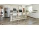 Bright, white kitchen with stainless steel appliances, a large island, and four counter stools at 260 Onset Way, Westfield, IN 46074