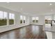 Bright living space featuring hardwood floors, large windows offering picturesque outdoor views, and a modern island at 260 Onset Way, Westfield, IN 46074
