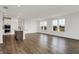 Spacious living area boasts hardwood floors, an island kitchen, and large windows showcasing scenic views at 260 Onset Way, Westfield, IN 46074