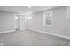 Large bedroom with gray carpet, neutral walls and natural light, adjacent to bathroom with tiled shower at 2920 E 11Th St, Indianapolis, IN 46201