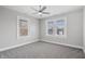 Bright bedroom featuring neutral walls, gray carpet, updated ceiling fan and double windows with blinds at 2920 E 11Th St, Indianapolis, IN 46201