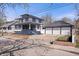 Charming two-story home features a spacious front yard, brick accents, and a detached three-car garage at 2920 E 11Th St, Indianapolis, IN 46201