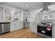 Modern kitchen with stainless steel appliances, white cabinets, and stylish backsplash at 2920 E 11Th St, Indianapolis, IN 46201