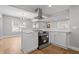 Open-concept kitchen with stainless steel appliances, white cabinetry, and seamless connection to the dining area at 2920 E 11Th St, Indianapolis, IN 46201