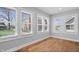 Sun-drenched living area with hardwood floors and multiple windows offering neighborhood views at 2920 E 11Th St, Indianapolis, IN 46201