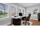 Bright home office with modern desk, comfortable chair, and lots of natural light from three windows at 2920 E 11Th St, Indianapolis, IN 46201