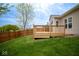 Back deck with green yard, brown wood fence, light siding, and a leafy green tree at 3168 Lodgepole Dr, Whiteland, IN 46184