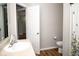Well-lit bathroom with a white sink, toilet, and modern finishes at 3168 Lodgepole Dr, Whiteland, IN 46184