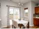 Dining area with a table set for four, a sliding door to the deck, and neutral decor at 3168 Lodgepole Dr, Whiteland, IN 46184