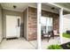 Inviting front porch area with seating, offering a relaxing spot with brick accent wall at 3168 Lodgepole Dr, Whiteland, IN 46184