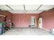 Spacious two car garage with shelving, utility equipment, and a red painted back wall at 3168 Lodgepole Dr, Whiteland, IN 46184
