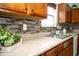 Close-up of the kitchen counter, showcasing the countertop, backsplash, sink, and fixtures at 3168 Lodgepole Dr, Whiteland, IN 46184