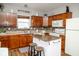 Well-lit kitchen featuring wooden cabinets, an island, modern appliances, and stylish backsplash at 3168 Lodgepole Dr, Whiteland, IN 46184